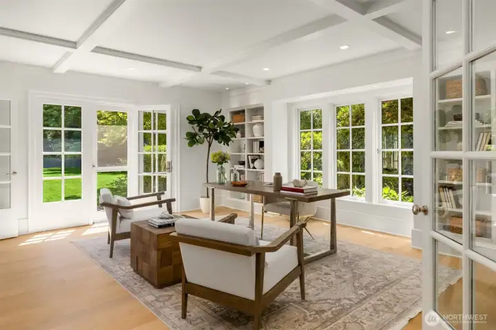 Sophisticated home office featuring a coffered ceiling and French doors leading to the yard. Sophisticated home office featuring a coffered ceiling and French doors leading to the yard.