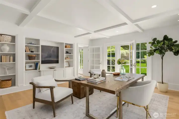 Refined home office featuring custom built-in shelving and French doors. Refined home office featuring custom built-in shelving and French doors.