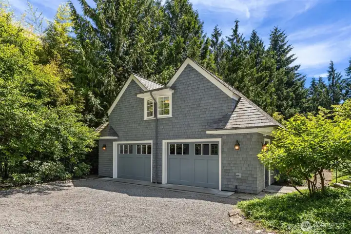 Charming shingle-style detached garage surrounded by mature trees. Charming shingle-style detached garage surrounded by mature trees.