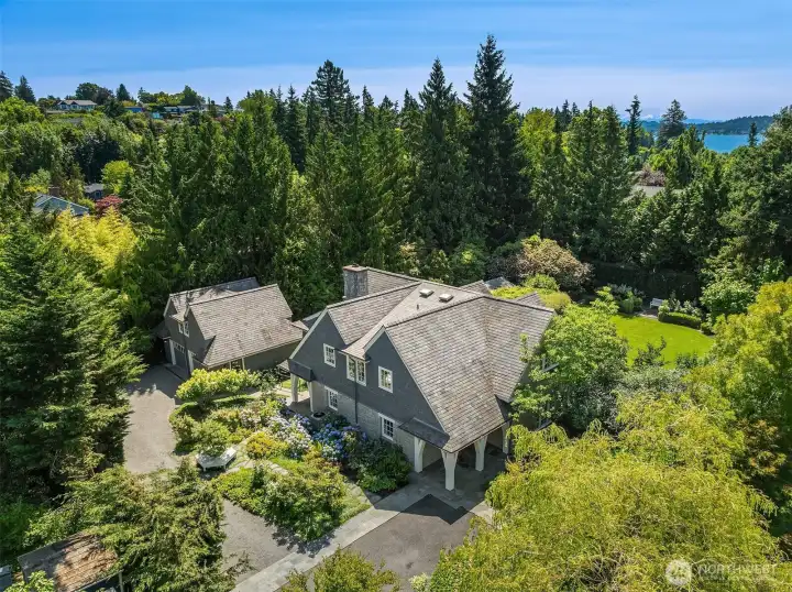 Aerial view showcasing the home's private, tree-lined setting. Aerial view showcasing the home's private, tree-lined setting.