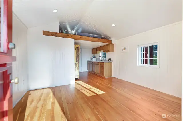 View just inside the door of the cabin. See loft area and kitchen.