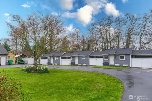 1.31 level acres with a 2400sf craftsman home PLUS 6 fully rented tiny homes!