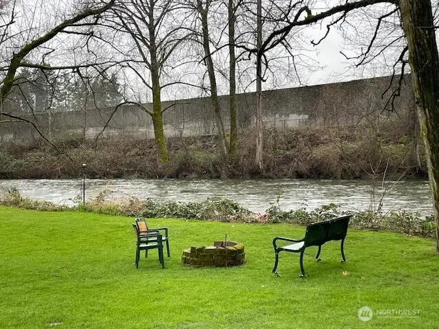 Residents enjoy the back yard firepit on the river's edge.
