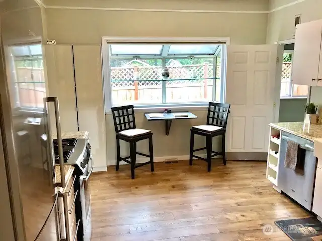 The kitchen offers an eat in area by the side window.