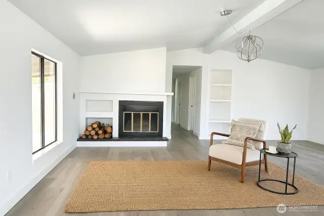 Virtually staged living space with wood burning fireplace