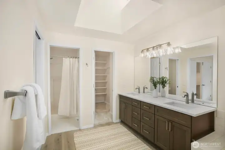 The Primary Bathroom glows with natural daylight.  The shower and toilet are in their own room for privacy and the walk-in closet is there as well.