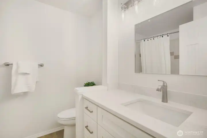 Full Bathroom on the Upper floor has a tub/shower, new flooring, new vanity with Quartz counter and new light fixture.  So fresh!
