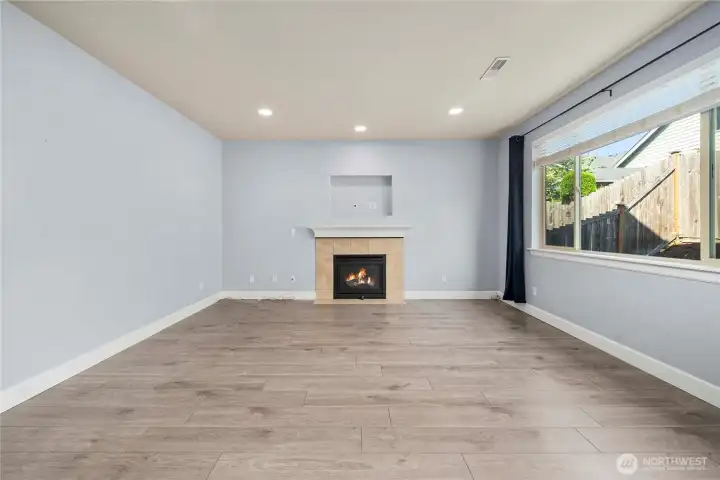 Living room with gas fireplace and tv nook