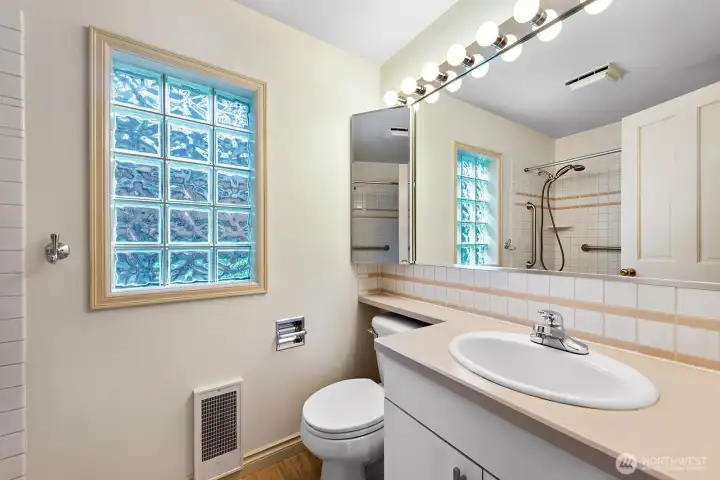Full Bath with Tile Tub Surround & brand-new LVP Flooring.