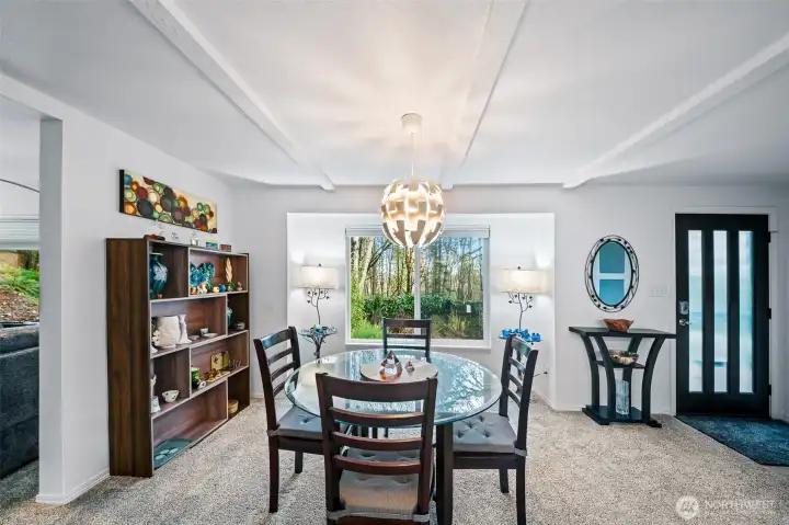 The spacious dining room has newer flooring and paint, a stunner of a chandelier, and views to nature. Plenty of room to entertain here.