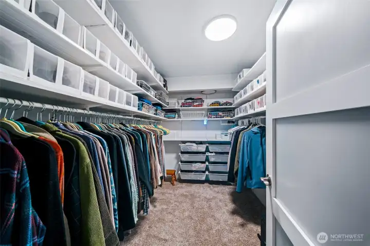 One of two primary closets, with extensive shelving for storage that is able to be reconfigured as you like it