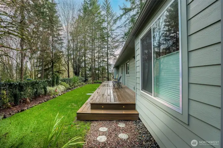 Front deck is surrounded by beautiful landscaping and is fully fenced. New app-controlled, six zone irrigation system makes maintenance easy