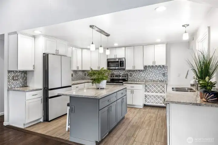 Stylish quartz countertops and SS appliances.