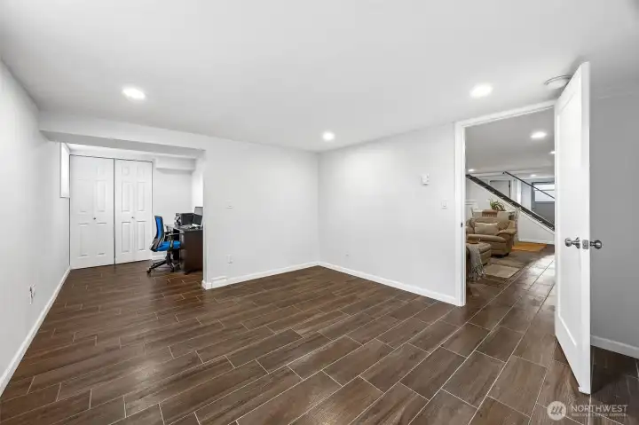 Large basement ADU bedroom with office nook and closet.