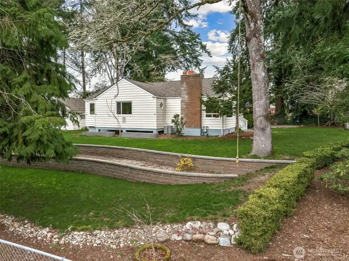 Private, park-like setting true to the charm found in this neighborhood, with mature heirloom trees and established rhododendron hedges.