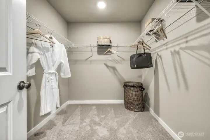 Primary suite walk in closet. Photos are for representational purposes only.  Colors and finishes may vary.