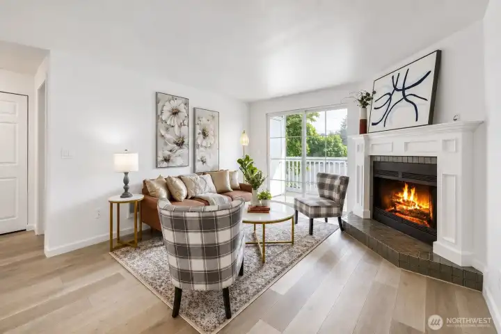 Bright living space with engineered hardwood floors, wood burning fireplace and new paint throughout.