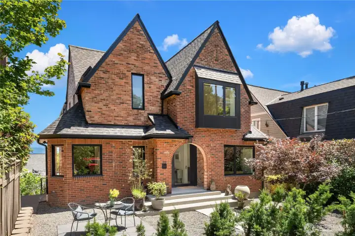 A brick Tudor from the front blends with neighboring houses. A brick Tudor from the front blends with neighboring houses.
