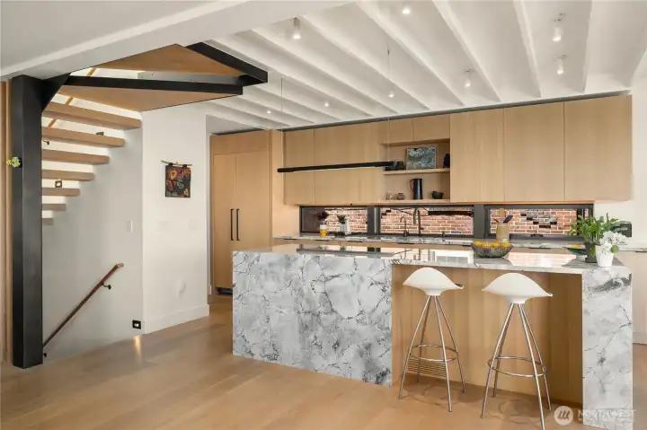 Cool ceiling and stair detail. Custom made rift oak kitchen cabinets and Italian granite on waterfall island. Cool ceiling and stair detail. Custom made rift oak kitchen cabinets and Italian granite on waterfall island.