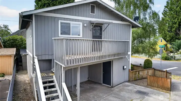 Duplex corner view showing Unit B deck and partially fenced yard