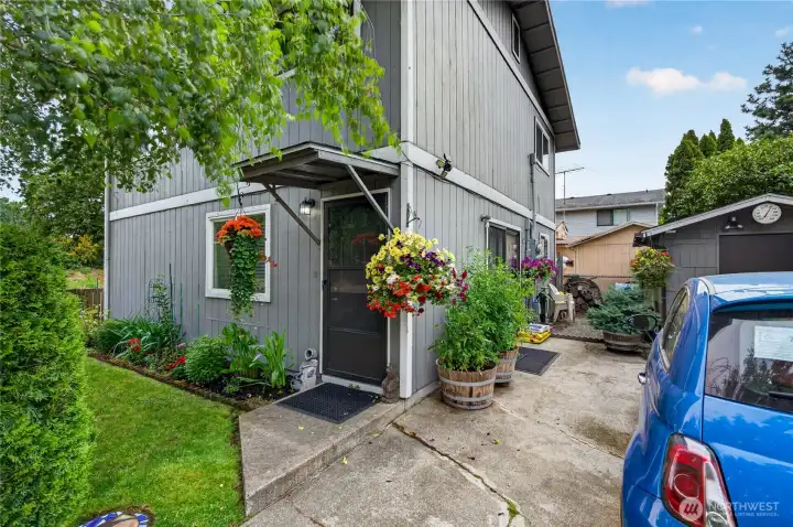 Unit A entry with lush landscaping and off street parking