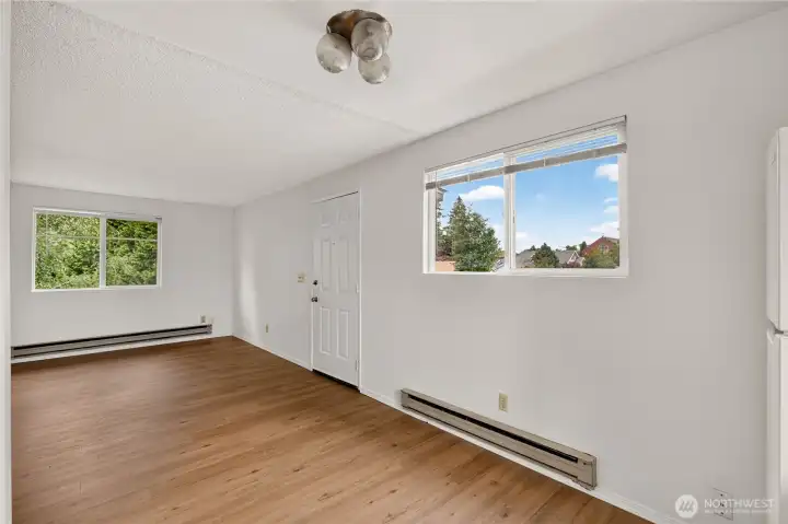 Bright living space with new flooring and natural light in Unit B