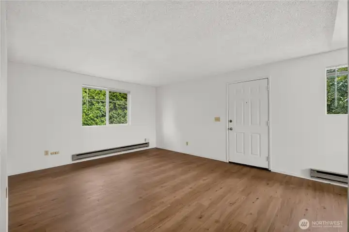 Living room with front entry door in Unit B