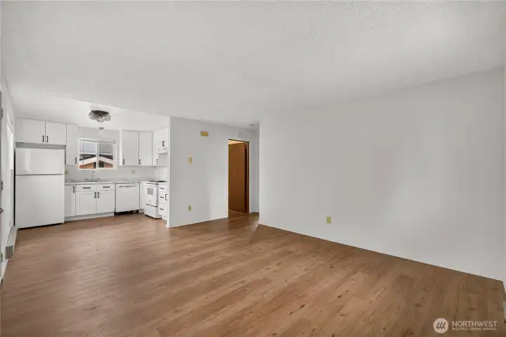 Open-concept flow from living room to kitchen Unit B