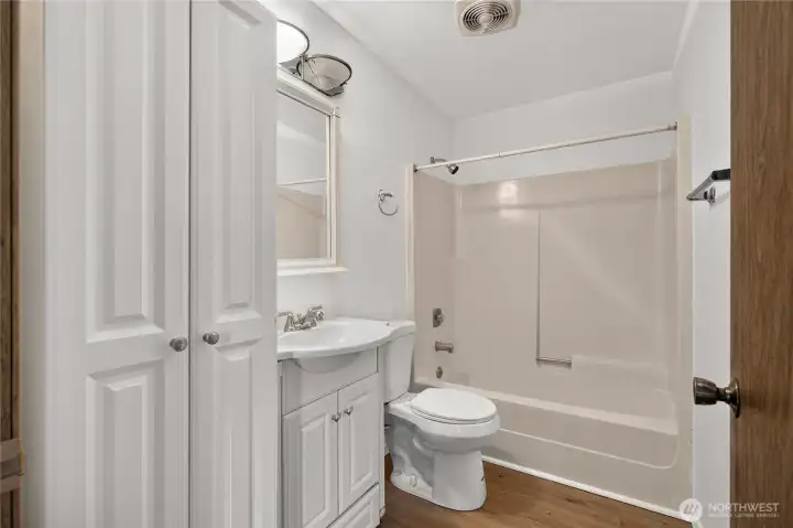 Updated bathroom with tub/shower combo and storage space