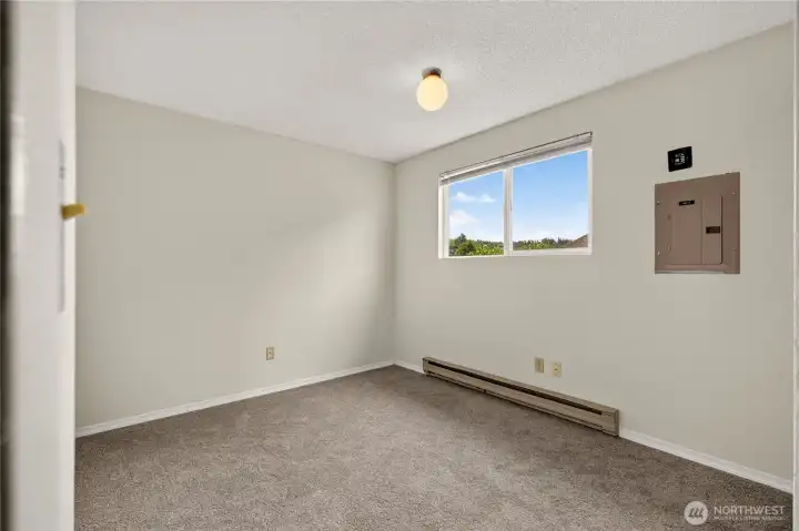 Unit B carpeted primary bedroom with natural light