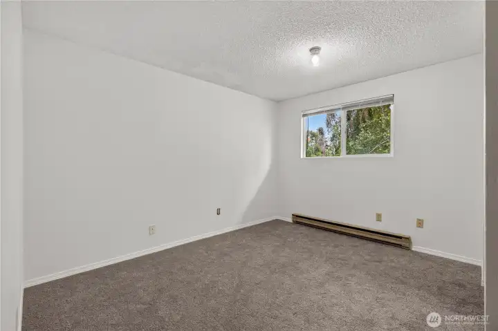Unit B second bedroom with wall to wall carpet