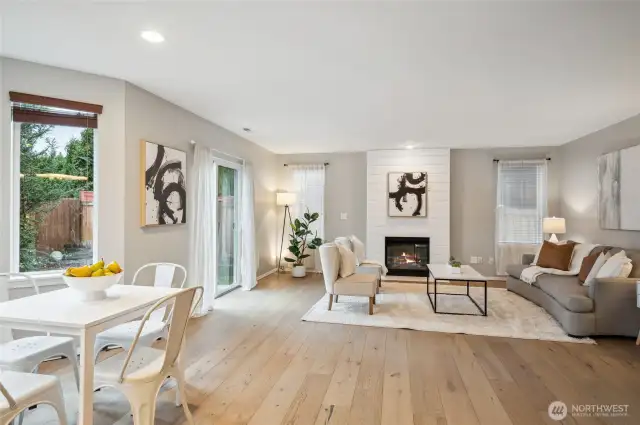 Wide plank flooring flows seamless throughout the kitchen, casual dining area, and the family room.