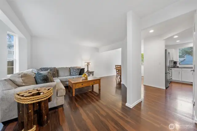 Looking in from front door: Living Room on left, flows into dining at far left, flows into kitchen on far right