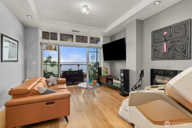Coffered ceilings add to the lux feeling in here. Wide plank wood flooring was a newer addition. Above the slider you have transom windows allowing lots of light into the home.