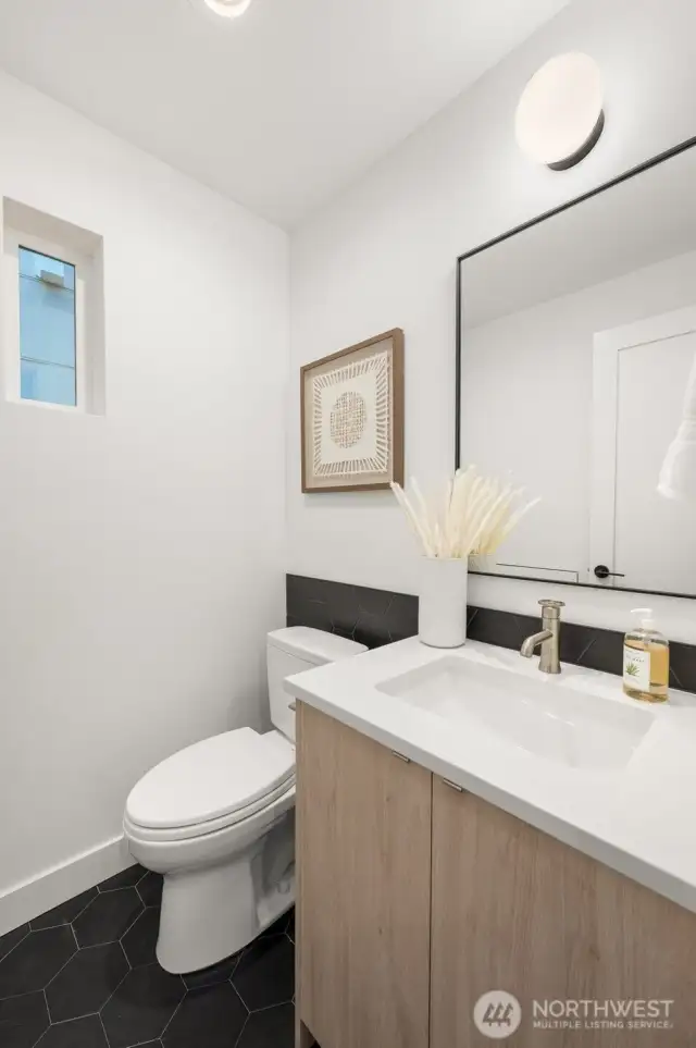A chic and functional powder room with refined touches and modern fixtures to impress your guests.