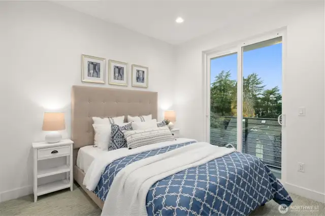 Step into the cozy elegance of this sunlit bedroom. Expansive windows frame serene views while filling the space with natural light, creating the perfect relaxing ambiance.