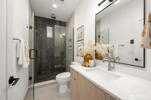 The primary bathroom offers modern functionality with a sleek vanity, ample storage, and thoughtful details to elevate your daily routine.