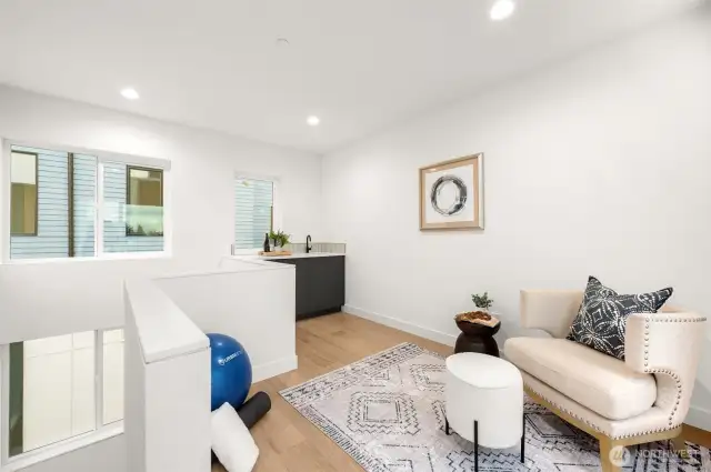 Step into the penthouse-level retreat with a built-in wet bar and wine fridge. Sunset views pour through the windows, inviting you to your expansive rooftop deck.