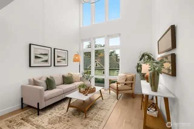 The spacious and inviting living room is perfect for cozy evenings or lively gatherings. Oversized windows frame Capitol Hill’s vibrant energy.