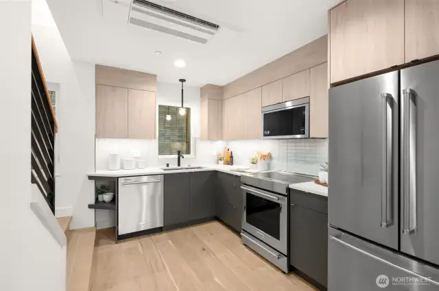 The heart of the home, this sleek kitchen features stainless steel appliances, designer cabinetry, and gorgeous views.