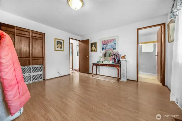 Large primary bedroom looking back towards hallway and en suite bathroom