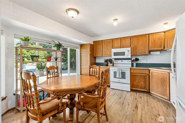 Enter into a bright, open kitchen with space for your table and ample storage.
