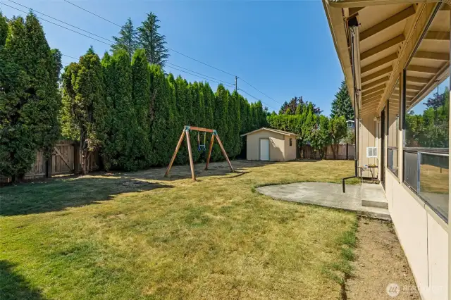 Lots of space in the back yard with privacy hedges. Shop in the back corner is more usable space!