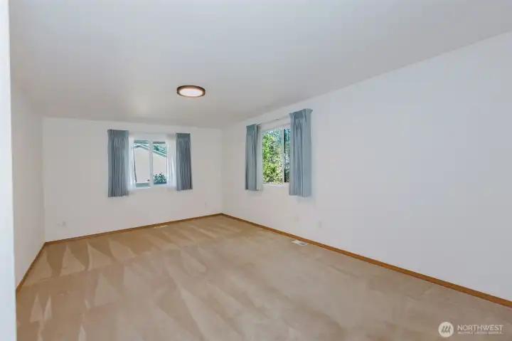 Huge primary suite with windows to the north and east