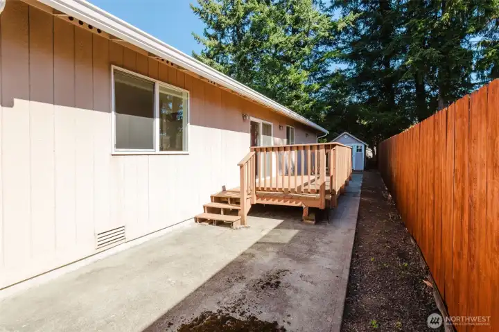 Low maintenance backyard space with newer deck and concrete patio