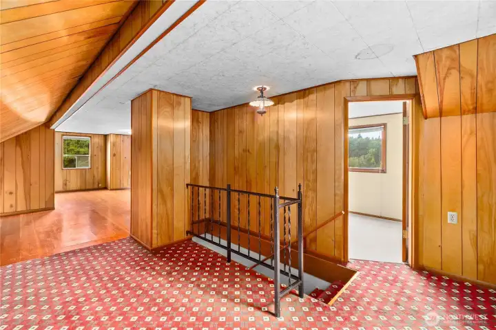 Upstairs you'll find a small room on the right and larger living area ahead.
