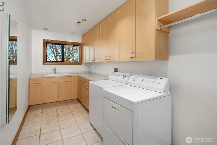 Large Laundry room between Primary bedroom and 2nd and 3rd bedrooms.