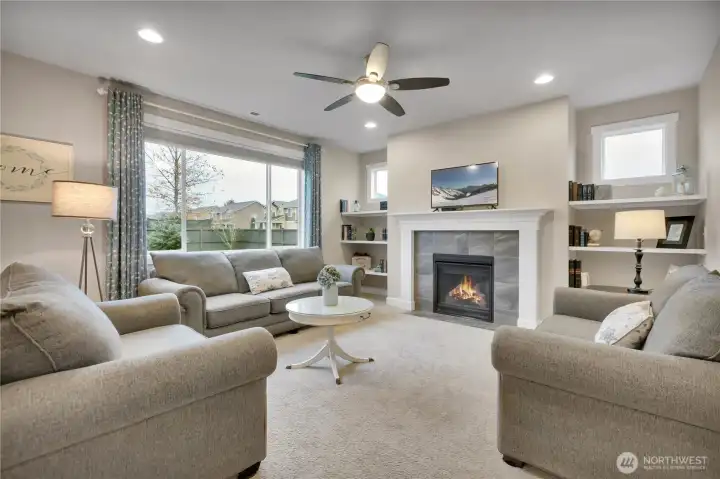 Large windows offer a view of the backyard. Gas fireplace.