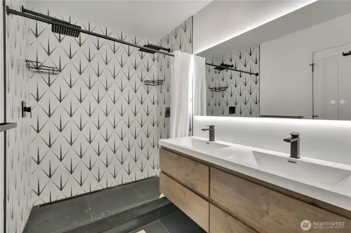 Remodeled primary bath with modern finishes.