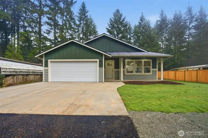 Fresh landscaping and a spacious driveway offer a warm and welcoming approach to the home